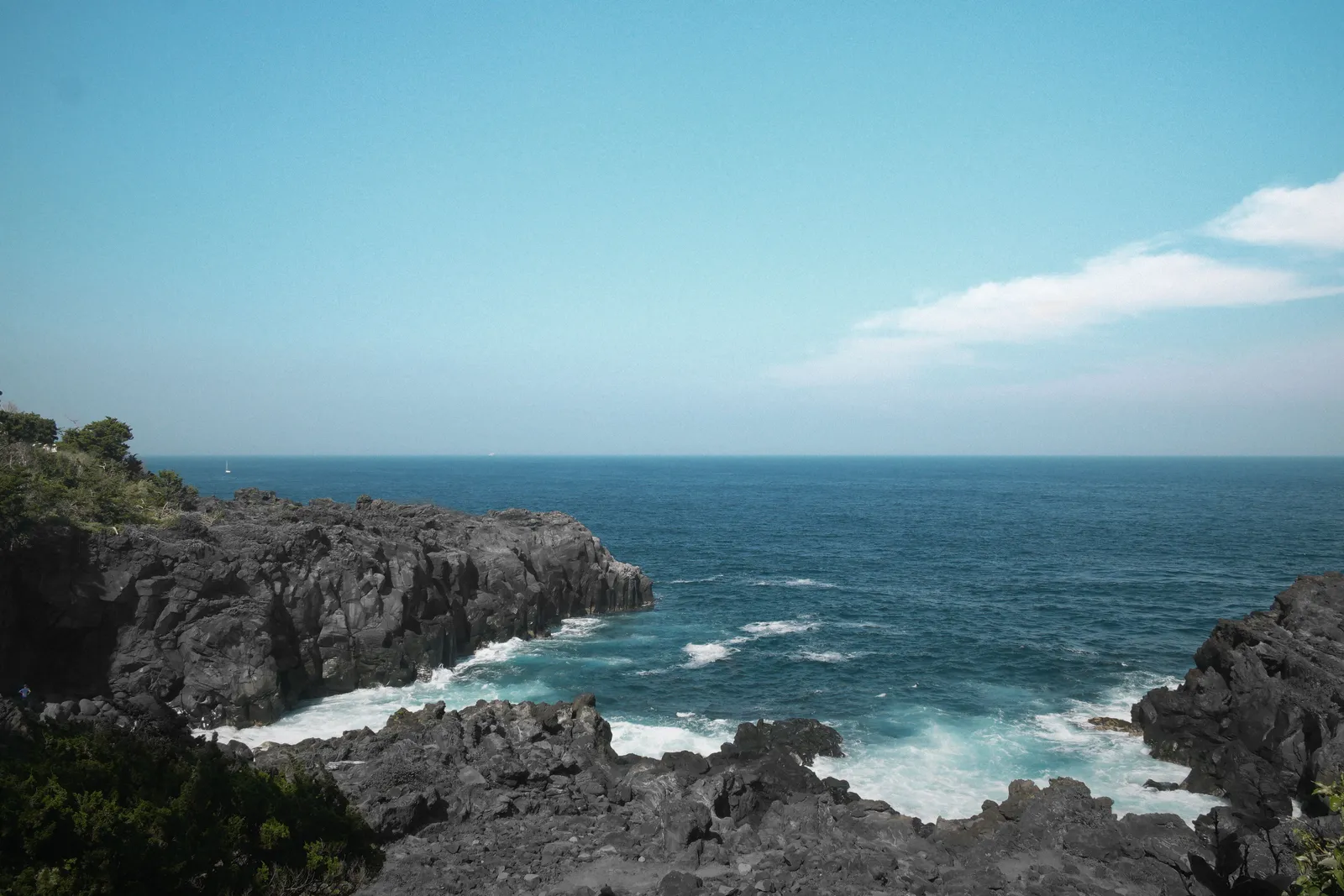 The rocky volcanic shoreline of the Izu peninsula with the Pacific beyond it