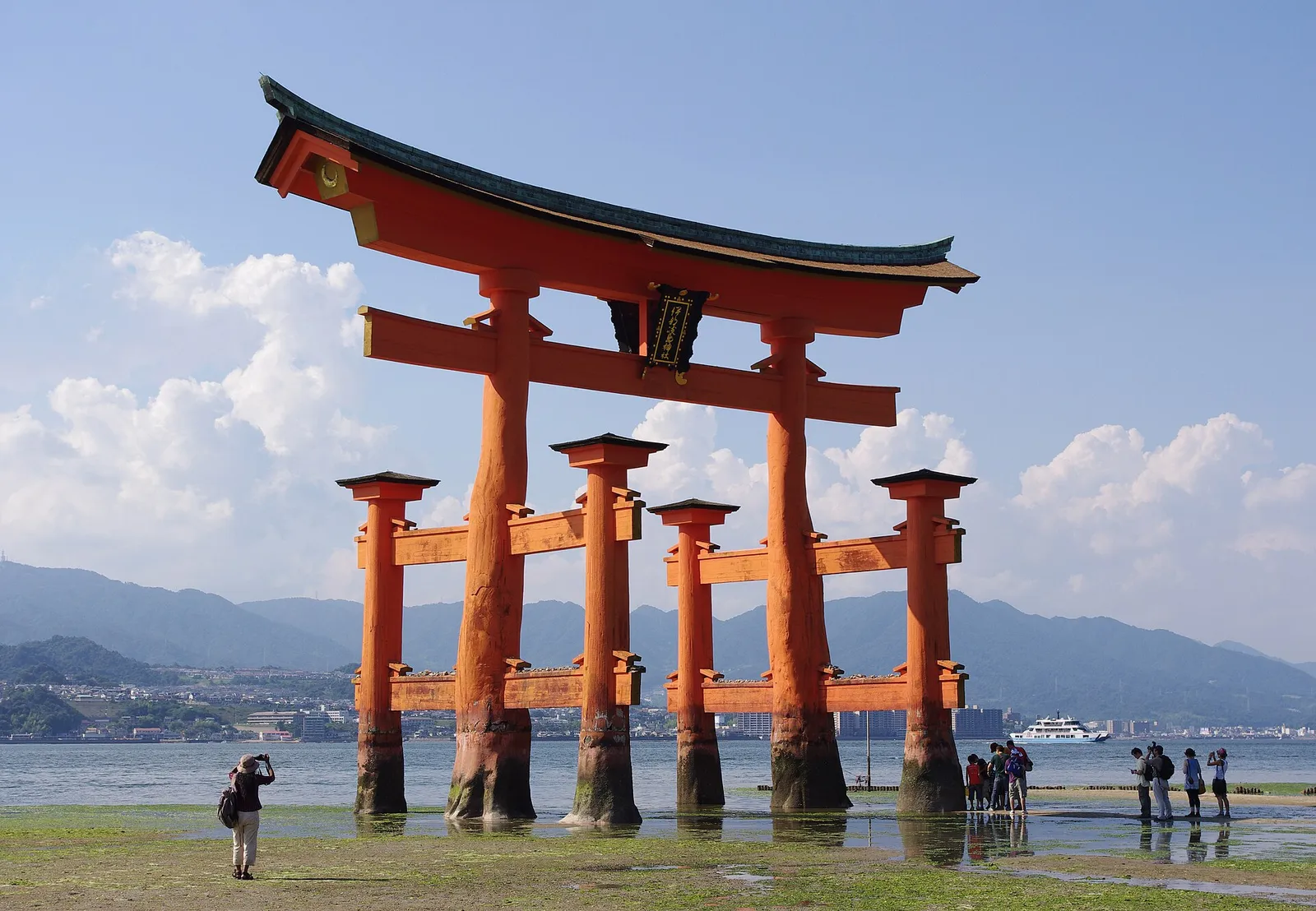 The red torii gate of Itsukushima Shrine standing in the sea at Miyajima, Japan
