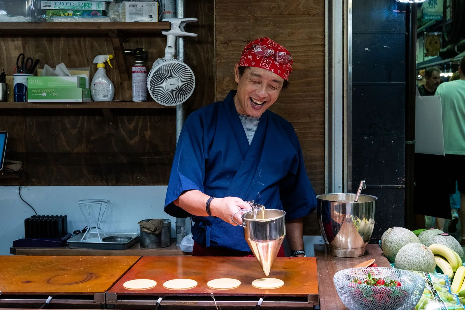 A cook preparing food at a counter in Hiroshima, Japan