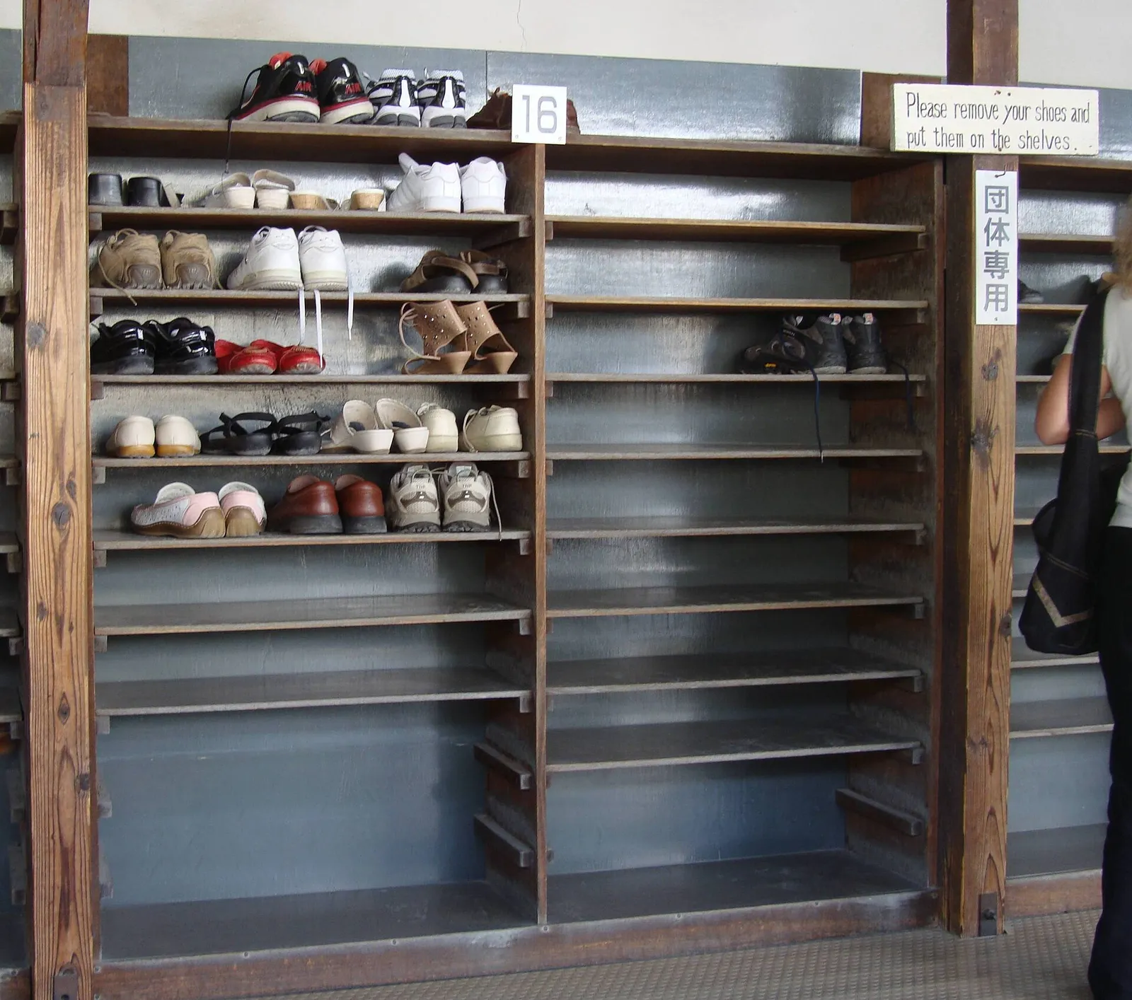 Shoes left at a raised entrance step before a tatami room in Japan