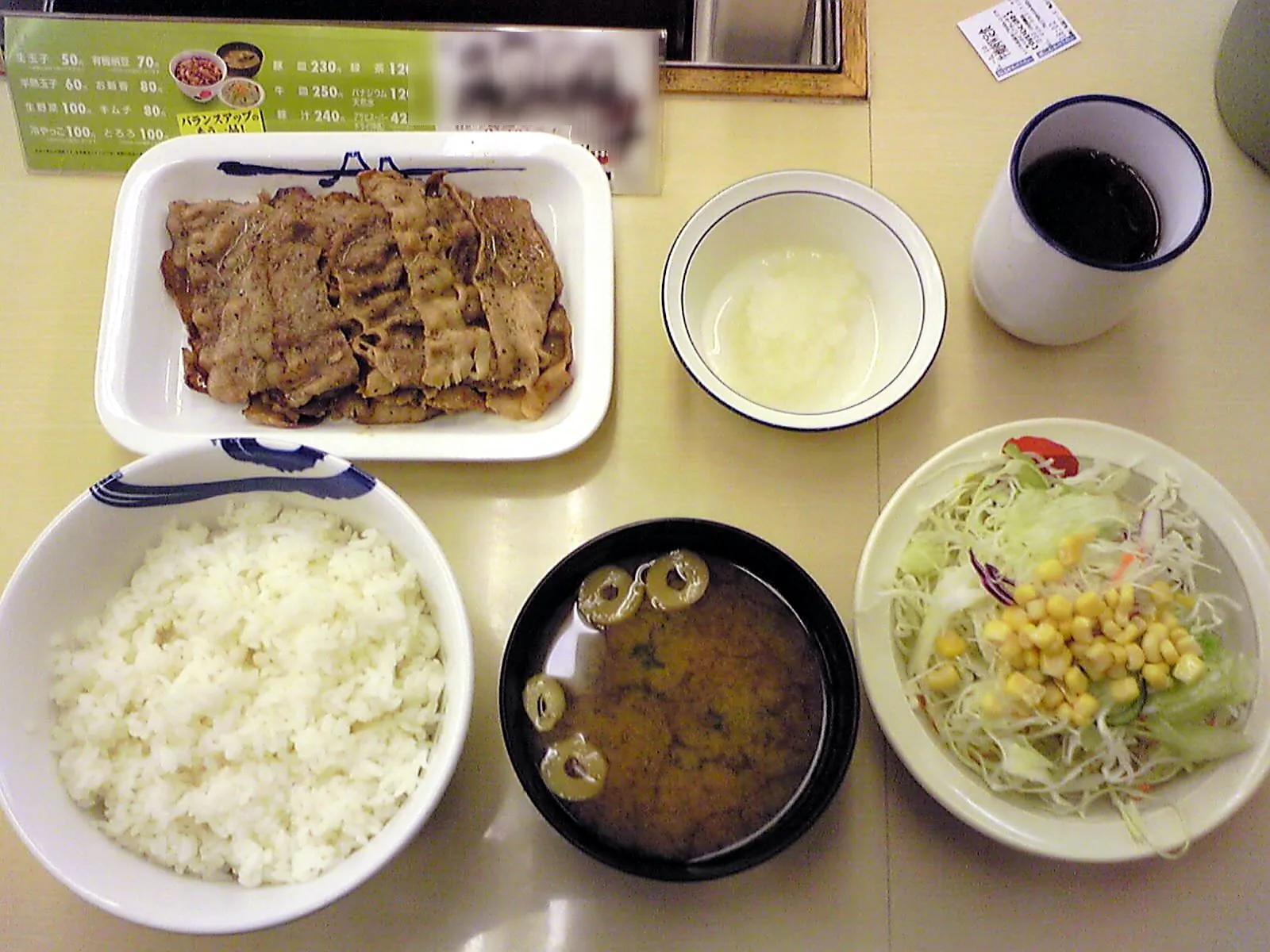 A Japanese meal set with rice, soup and side dishes on a restaurant table