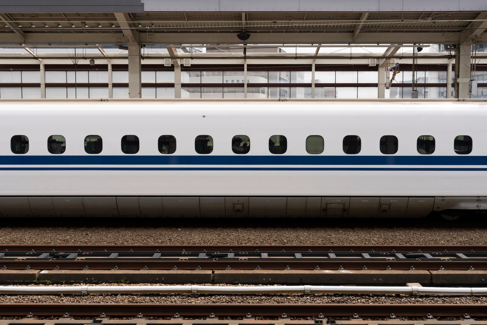 A shinkansen bullet train waiting at a platform in a Japanese station