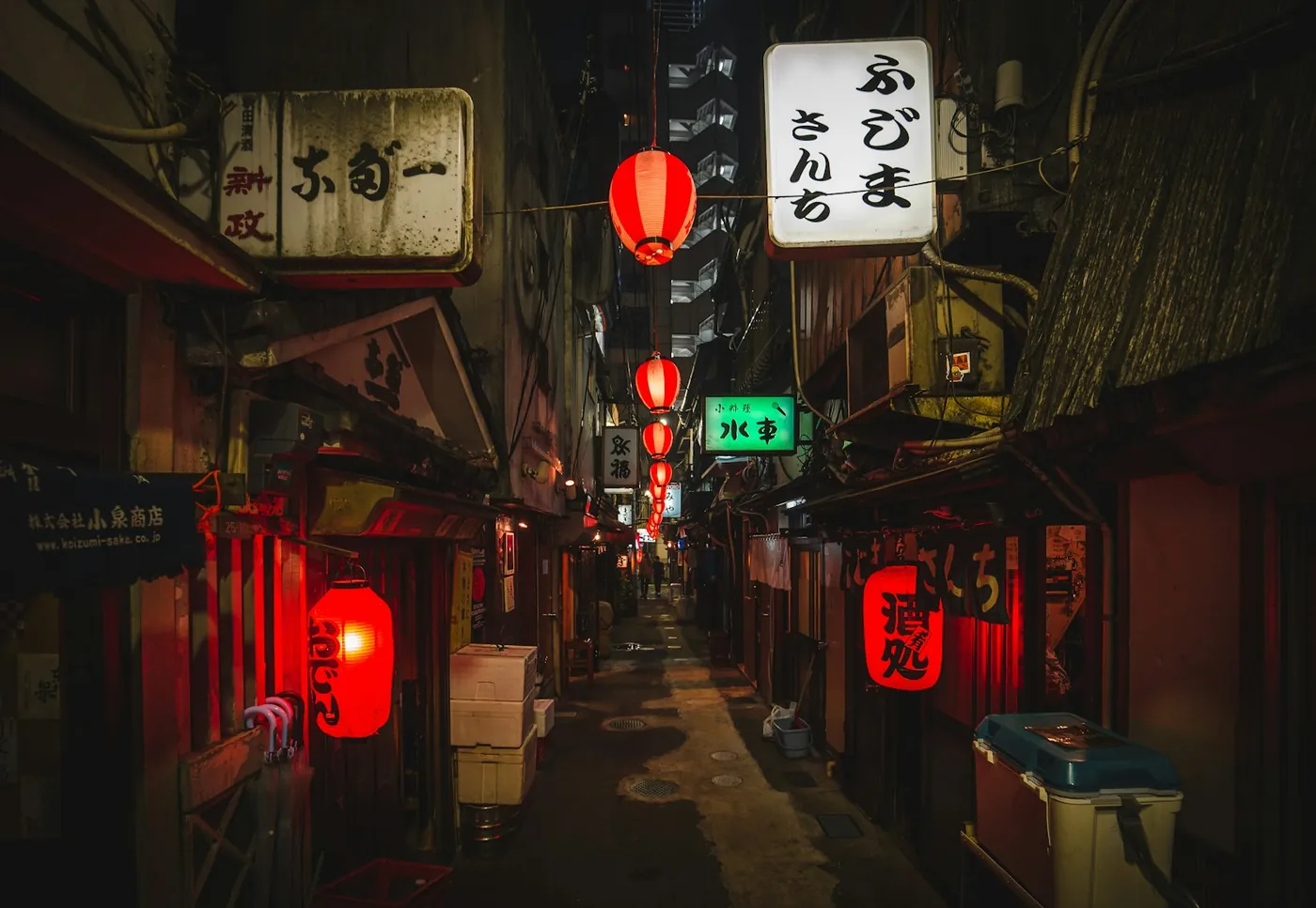 A quiet traditional street of low-rise buildings and lanterns in the Asakusa neighborhood of Tokyo